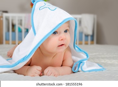 Cute Little Baby Boy In A Hooded Towel After Bath