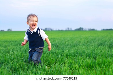 A cute little baby boy sit in the grass - Powered by Shutterstock