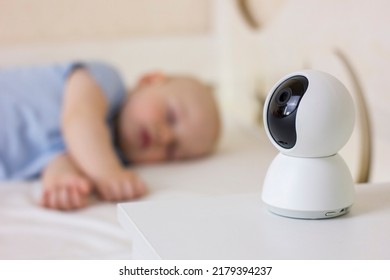 Cute Little Baby Boy Sleeping On Bed At Home With Baby Monitor Camera.