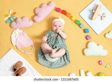 Cute Little Baby With Clothing And Accessories On Color Blanket, Top View