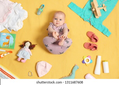 Cute Little Baby With Clothing And Accessories On Color Blanket, Top View