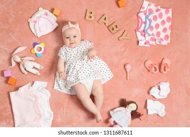 Cute Little Baby With Clothing And Accessories On Color Blanket, Top View