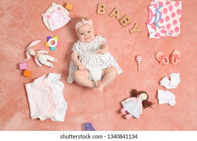 Cute Little Baby With Clothing And Accessories On Color Blanket, Top View