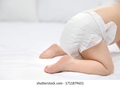 Cute Little Baby In Diaper On Bed, Closeup. Space For Text