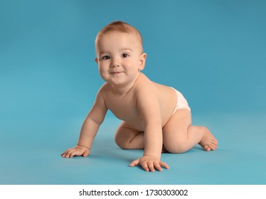 Cute Little Baby In Diaper On Light Blue Background