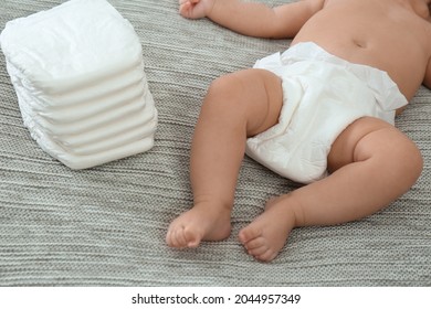 Cute Little Baby In Diaper On Grey Blanket, Closeup