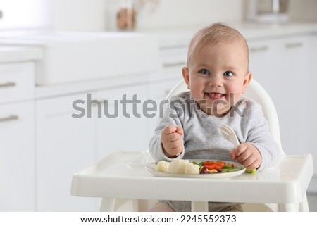 Similar – Image, Stock Photo Portrait of happy cute boy in casuals and straw hat with missing teeth smiling looking at camera and wearing backpack while waiting at airport terminal