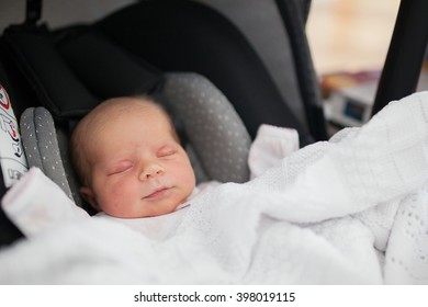 Cute Little Baby Girl Sleeping In Car Seat.