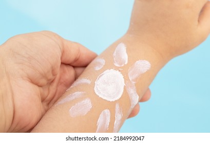 Cute Little Baby Hand And Sun Shape Drawn With Protective Cream,pool Water Background.kid Red Burned Skin,sun Damaged.sunblock Protective Cream Long Lasting.mother Hand Holding Child Hand.vacation