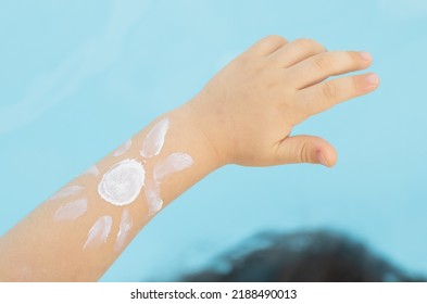 Cute Little Baby Hand And Sun Shape Drawn With Protective Cream,pool Water Background.kid Red Burned Skin,sun Damaged.sunblock Protective Cream Long Lasting.mother Hand Holding Child Hand.vacation