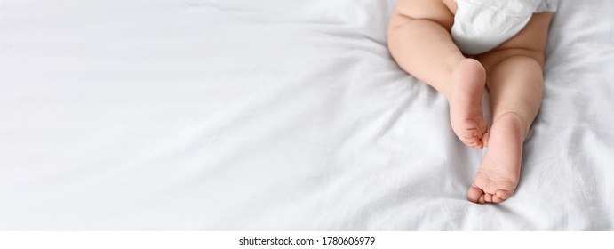 Cute little baby lying on bed, space for text. Banner design