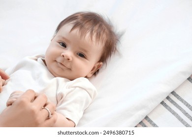 Cute little baby with mother lying on bed, closeup - Powered by Shutterstock