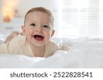 Cute little baby on bed at home