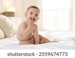 Cute little baby on bed at home