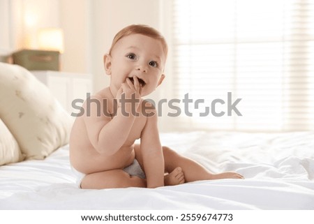 Cute little baby on bed at home