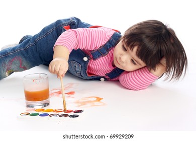 Cute Little Baby Painting Lying On The Floor