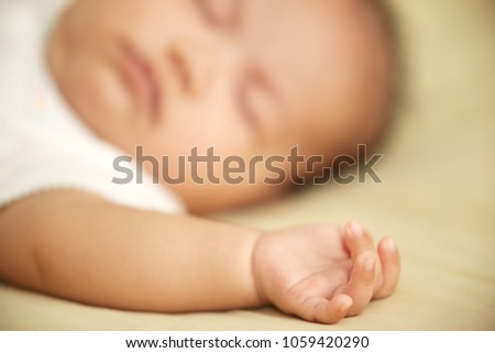 Similar – Newborn baby girl sleeping on blue sheets at home