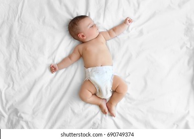 Cute Little Baby Sleeping On Bed At Home