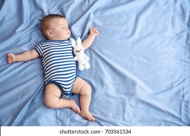 Cute little baby sleeping on bed