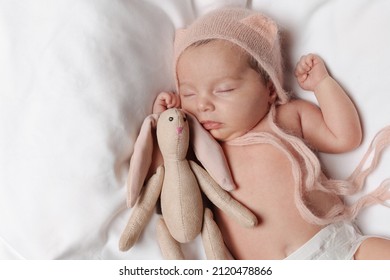 Cute Little Baby With Toy Bunny Sleeping On Soft Bed, Top View