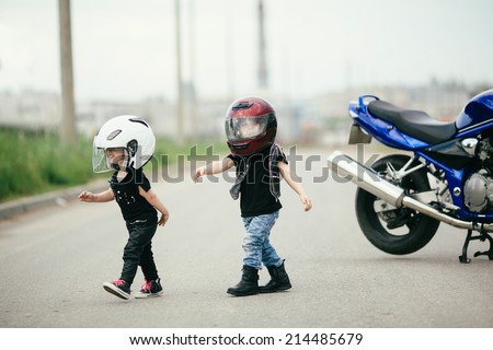 cute little biker on road with motorcycle