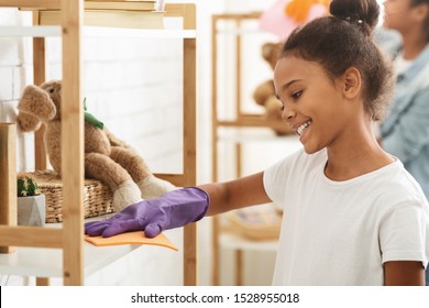 Cute Little Black Girl Cleaning Dust In Her Room, Copy Space, Close Up