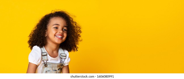 Cute Little Black Girl Portrait, Pretty Small Child Sincerely Laughing, Smiling Over Yellow Background, Long Horizontal Banner, Wide Shot, Panorama