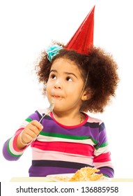 Cute Little Black Three Years Old Girl With Fuzzy Hair And Party Hat Eating Birthday Cake With Spoon Isolated On White