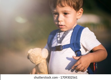 Cute, Little, Blond Boy Holding Teddy Bear In Hand. Imaginary Friend