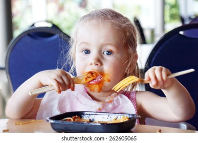 Cute Little Blond Girl Eating Spaghetti Pasta Making A Mess