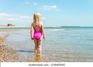 little girl in pink bathing suit