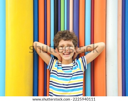 Similar – Image, Stock Photo Brown-haired boy with an athletic physique on an athletic oval massages his muscles with a foam roller for better recovery. Post-workout