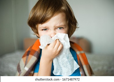 Cute Little Boy Blowing His Nose Into A Handkerchief.