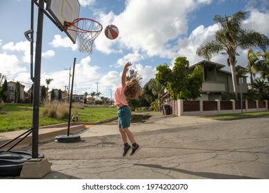 Cute little boy child jumping with basket ball for shot. Cute child playing basketball.