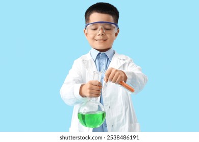 Cute little boy conducting experiment with chemistry flasks on blue background - Powered by Shutterstock