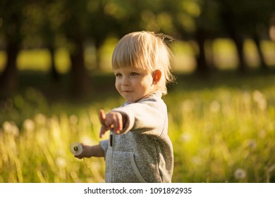 cute little boy with dandelions in park - Shutterstock ID 1091892935