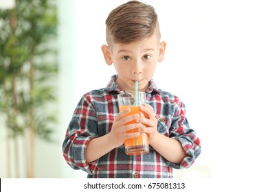 Cute little boy drinking juice at home - Powered by Shutterstock