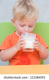 Cute Little Boy Drinking Milk From Glass