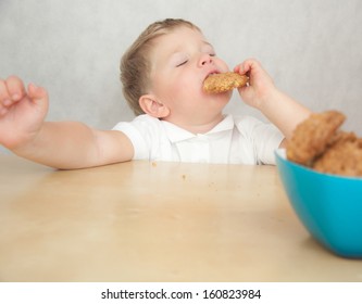 Cute Little Boy Eating Cookies