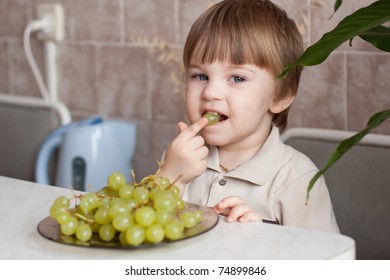 Cute Little Boy Eating Grapes