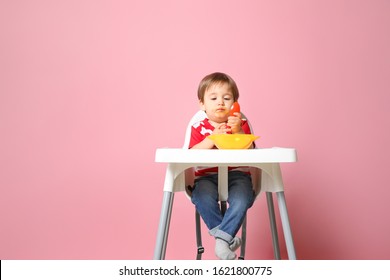 Cute Little Boy Eating Tasty Baby Food Against Color Background