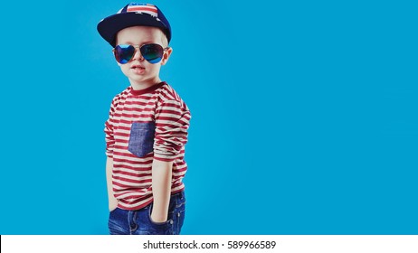 Cute little boy in elegant clothes and sunglasses. Kids fashion.