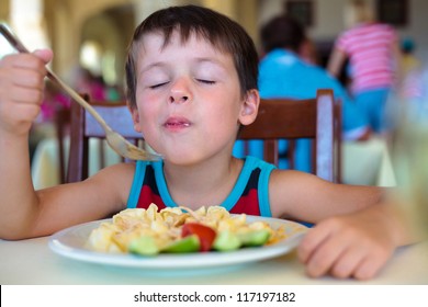 Cute Little Boy Enjoying Food