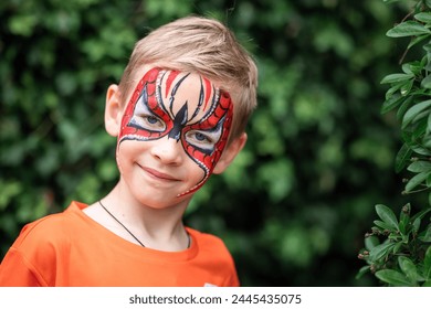 Cute little boy with face paint. Face painting, kid painting face at the birthday party or on holidays - Powered by Shutterstock