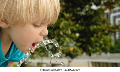 Cute Little Boy Face Portrait Drink Water In A Park From Drinking Fountain Slow Motion