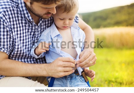 Beautiful boy getting a haircut with scissors