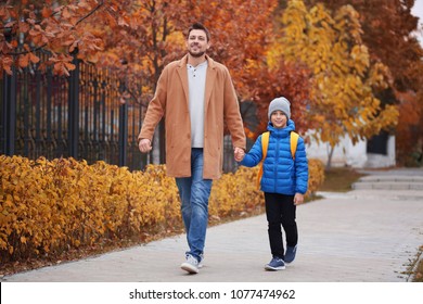 Cute little boy going to school with his father