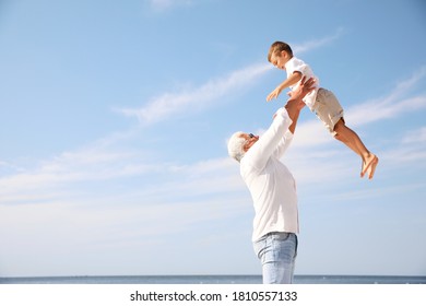 Cute little boy with grandfather having fun near sea - Powered by Shutterstock