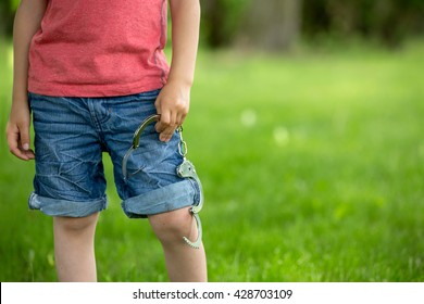 Cute Little Boy With The Hand Cuffs On His Hands, Playing