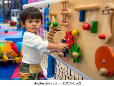 Cute Little Boy Having Fun In Kids Amusement Park And Indoor Play Center In Playground.